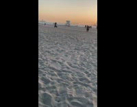 Storm trooper drive motorcycle wheelie beach sunset