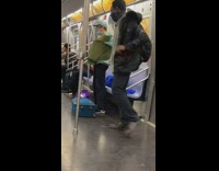 Guy puts red plastic tray under shirt