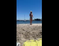 Woman tries to do gymnastics at beach
