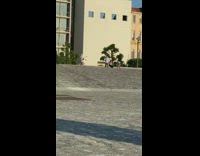 White shirt girl dances outside building bells 