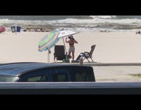 Woman white shorts take selfie beach waves