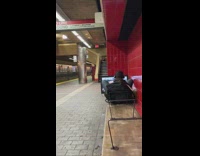 Guy sits on bench with video game monitor 