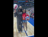Girl poses with woman basketball player 