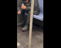 Man on subway eats chocolate from floor