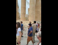 Collab IITW - Woman in white top poses in front of the ruins around the tourist