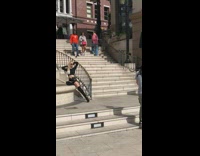 Woman in black crop top sweater poses near the stairs