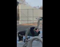 Man does sit ups with pet cat