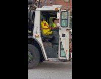 Garbage man with large pikachu buckled in