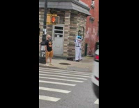 Two people white spacesuit costumes MTV sign