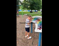 Kid plays the xylophone at the park