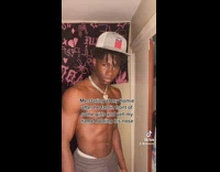 Guy white hat shirtless tanding staring