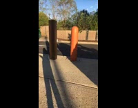 Girl jumps over tall orange pole and falls face first into concrete