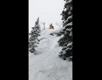 Guy skis down steep mountain and tumbles down, friends laugh