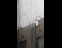 Collab winy - Two guys use bucket scoop water on rooftop