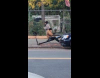 Collab WINY - Man do rowing exercise machine on street