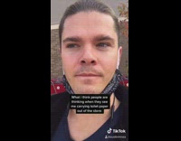 Guy carries toilet paper out of store 