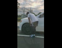 Man uses air pump for his white car tire