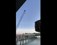 Guy jumps off construction crane into water