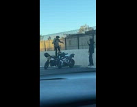 Man stands on the motorbike and jumps