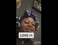 Woman with hair rods sings about love