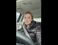 Girl in car with fish in container 