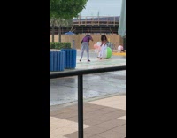 White pants girl sits green ball balloons 