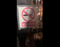 Kid reads no smoking as no weeds sign