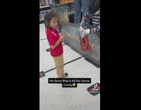 Kid tries to get candy from the statue