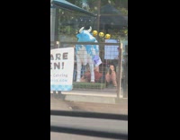 Woman lay under cow statue drink udder