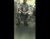 Guy does bicep gurls with dumbbell on subway train