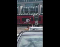 Black speedo guy center road median train 