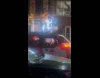 Man singing on top of moving jeep