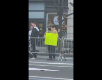 Man holding funny poster cheering on skinny people at NY marathon