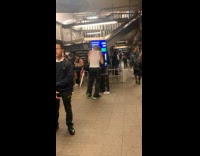 Two people dances to music at subway