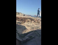 Collab Kook Of The Day - Guy in wetsuit blue goggles sits on bodyboard and gets up to go into the water at beach