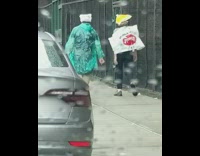 2 people wear plastic bags in the rain 