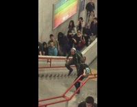 Guy in headphones yells and sings up metro stairs 