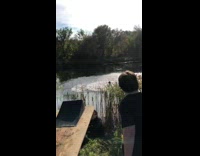 Biker rides over ramp into lake 