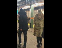 Woman stands against pillar upside down and dances to banjo music 