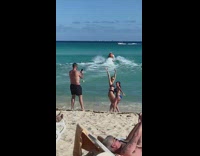2 women poses for a picture at the beach 