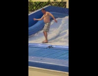 Man surfs on wave ride simulator and falls