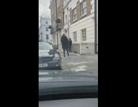 Collab IITW - Girl poses by railing people walk by