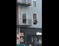girl sticks head out blue house window