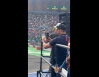 Man takes picture of wine at racetrack