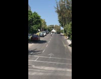 Girl skateboards downhill and falls forward 