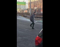 Collab WINY - Man gray jacket dances while crossing street 
