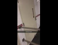 Police officers look through peep hole through door window