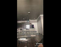 Guy hold speaker ceiling loud neighbor