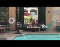 Two girls white phone tripod pool fountain