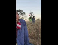 Green face body paint black dress grass